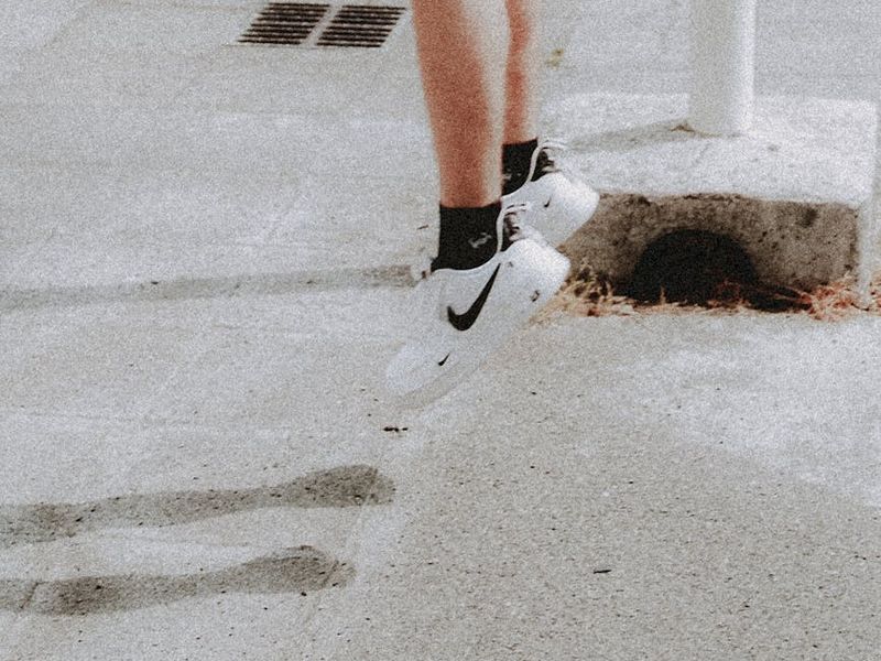 Detail of a person's sneakers during a jump move.